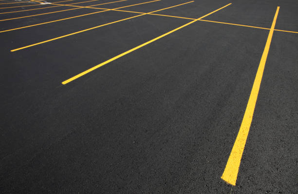 Freshly paved asphalt parking lot with new yellow line striping in Louisville, KY